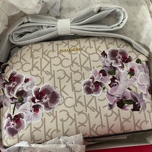 Calvin Klein bag. Floral and sig. Box is damaged. Sending in a new box.